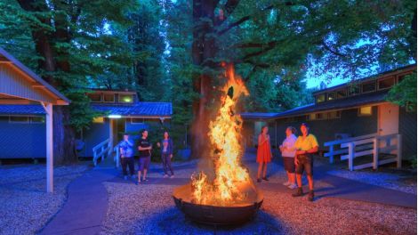 Guests chatting around a fire pit at Myrtleford Holiday Park
